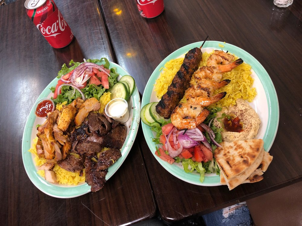 Two Al Basha Grill combo platters with grilled meat, shrimp, rice and hummus